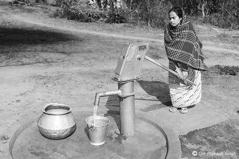 Collecting water from a community handpump in Seraikela-Kharsawan district, Jharkhand, India